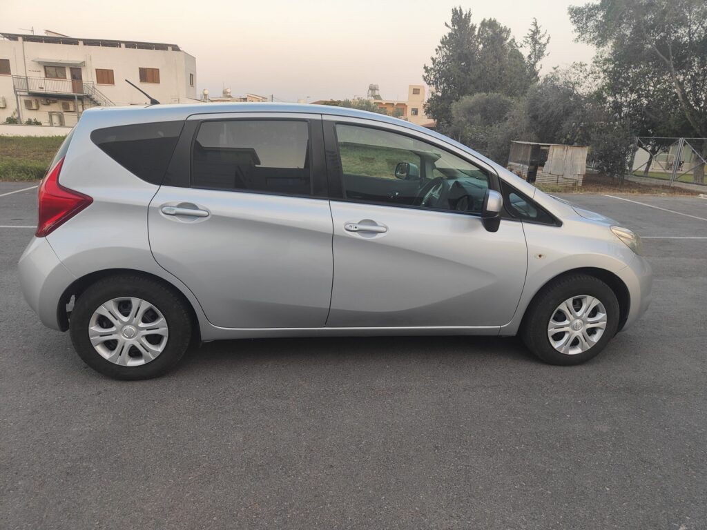 Silver Nissan Note automatic hire car, side profile, parked in Larnaca Cyprus