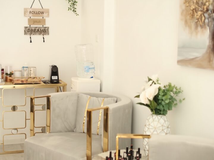 Nail bar and lounge area inside a beauty salon in Larnaca, Cyprus, with gel polish display, velvet armchairs and gold fittings