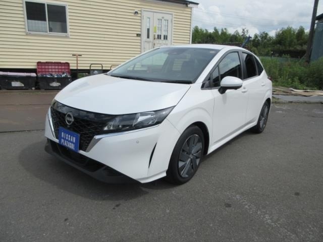 White 2023 Nissan Note hybrid hatchback, front three-quarter view